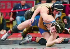  ?? SARAH GORDON/THE DAY ?? Stonington’s Sam Light, top, wrestles Jared Swett of Lyman/Windham Tech in the 138-pound final at the ECC wrestling tournament on Saturday at Fitch High School in Groton. Light won 6-0.