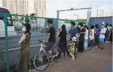  ?? Jae C. Hong / Associated Press ?? People outside Tokyo’s Ariake Urban Sports Park wait to see Yuto Horigome, the first Olympic skateboard gold medalist.