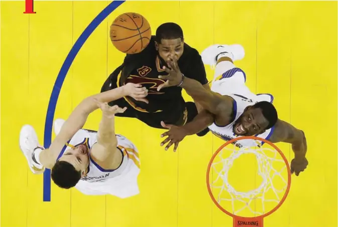  ??  ?? OAKLAND: Cleveland Cavaliers’Tristan Thompson, center, is defended by Golden State Warriors’ Draymond Green, right, and Klay Thompson during the second half in Game 2 of basketball’s NBA Finals Sunday, in Oakland, Calif. — AP