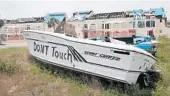  ?? SCOTT OLSON/GETTY ?? A boat sits in front of an apartment complex that was destroyed by Hurricane Michael in Panama City.