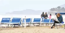  ?? Reuters/File ?? People enjoy at the beach in Castiglion­e della Pescaia, Italy.