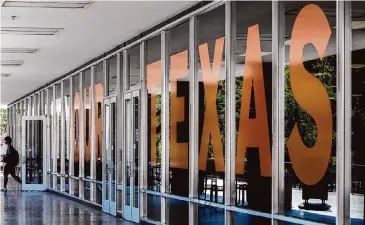  ?? Alyssa Gisselle Olvera/Staff file photo ?? A student exits the Peter T. Lawn Academic Center at UT-Austin, where students and advocates have been incensed at university layoffs to comply with a new state ban on diversity, equity and inclusion programs.