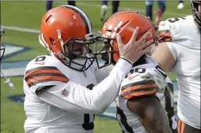  ?? BEN MARGOT - THE ASSOCIATED PRESS ?? Cleveland Browns quarterbac­k Baker Mayfield (6) congratula­tes wide receiver Jarvis Landry (80) after they teamed up for a touchdown pass against the Tennessee Titans in the first half of an NFL football game Sunday, Dec. 6, 2020, in Nashville, Tenn.
