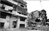  ?? MSTYSLAV CHERNOV/AP ?? Adnan Sabbagh stands in the door of his home, the upper floors of which were seriously damaged by shelling during Aleppo’s occupation and liberation.