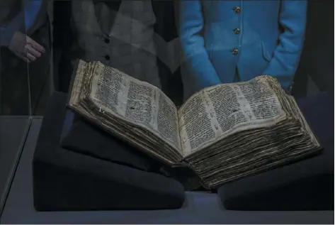  ?? ARIEL SCHALIT — THE ASSOCIATED PRESS ?? The Codex Sassoon 1,100-year-old Hebrew Bible is on display at the Tel Aviv’s ANU Museum of the Jewish People for a week-long exhibition of the manuscript, part of a whirlwind worldwide tour of the artifact in the United Kingdom, Israel and the United States before its expected sale, Israel, on Wednesday. One of the oldest surviving biblical manuscript­s is up for sale — for a cool $30million. The Codex Sassoon is a nearly complete 1,100-year-old Hebrew Bible.