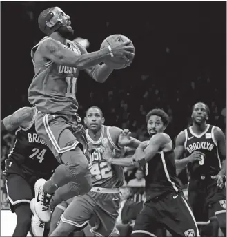  ?? FRANK FRANKLIN II/AP PHOTO ?? Kyrie Irving of the Celtics (11) drives to the basket during the second half of Tuesday night’s game against the Nets at New York. Irving scored 25 points as the Celtics won 109-102.