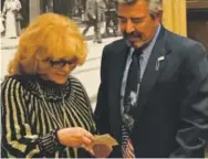  ??  ?? Ann-Margret meets with Vietnam War veteran David Garcia in Denver on Sunday. Garcia showed her a photo taken 50 years ago when he pushed his way through a crowd on a military base in Vietnam to ask for her autograph. Bruce Finley, The Denver Post