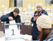  ?? — AFP photo ?? A man casting his ballot at a mobile polling station during early voting in Russia’s presidenti­al election in Mariupol, Russian-controlled Ukraine, amid the Russia-Ukraine conflict.