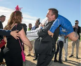  ?? JOSEPH JOHNSON/STUFF ?? Ecstatic Australian owner Danny Zavitsanos tosses winning driver and co-trainer Mark Purdon over his shoulders after Cruz Bromac won the New Zealand Cup at Addington last year in mid-November. It is possible he could return to defend the title.