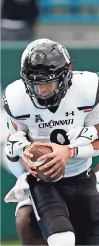  ?? GERALD HERBERT/AP ?? Cincinnati quarterbac­k Desmond Ridder (9) is sacked by Tulane linebacker Marvin Moody for a safety during the first half in New Orleans on Saturday.