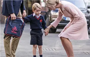  ??  ?? First day at school: George is welcomed by teacher, Helen Haslem