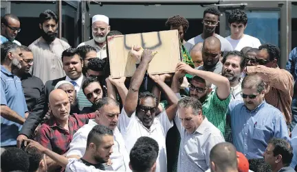  ?? JUSTIN TANG/THE CANADIAN PRESS FILES ?? Abdirahman Abdi’s casket is carried out of the Ottawa Main Mosque after his funeral last July 29.