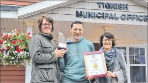  ?? ERIC MCCARTHY/JOURNAL PIONEER ?? The Town of Tignish won the Communitie­s in Bloom class of champions categories for communitie­s with population­s up to 4,500. They received five blooms and a gold rating from the judges. From left are Jamie McHugh, Roger Gaudet and Karen Gaudet-Gavin.