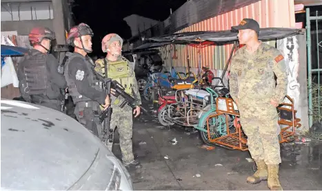  ?? MARK PERANDOS ?? TIGHTENED SECURITY. After the riot of contending candidates, the Task Force Davao has tightened security at Brgy. 23-C, Quezon Boulevard, Davao City.