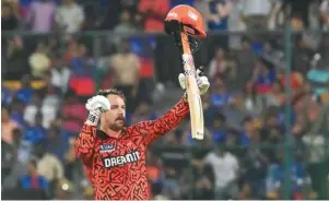  ?? (AFP) ?? Sunrisers Hyderabad’s Travis Head celebrates after scoring a century during the IPL match against Royal Challenger­s Bengaluru in Bengaluru yesterday.