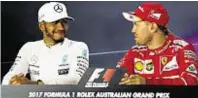  ??  ?? Still smiling: Defeated Lewis Hamilton, left, with Melbourne winner Sebastian Vettel