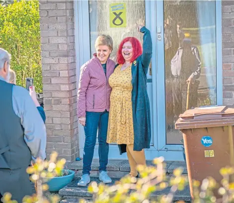  ?? ?? DOORSTEPPE­D: First Minister Nicola Sturgeon meets with residents in Loanhead, Midlothian, on the campaign trail.