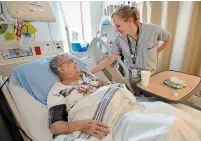  ?? BARRY GRAY THE HAMILTON SPECTATOR ?? Nurse Erin Chaffe checks on dialysis patient Rose Bilodeau in St. Joseph’s Hospital’s recently renovated dialysis unit.