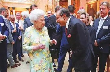  ??  ?? Queen Elizabeth II meets Yousuf Ali M.A. from Y Internatio­nal (UK) Ltd, during a reception for winners of the Queen’s Awards for Enterprise, at Buckingham Palace. The award ceremony was attended by Anne Underwood, Lord Mayor of Birmingham, and other...