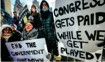  ?? AP ?? NO PAY CHEQUES: Government workers and their supporters hold signs during a protest in Boston. —
