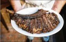  ?? COURTESY OF CALEB CHANCEY ?? The 18-ounce prime bone-in ribeye fills the plate at Helen in Birmingham, Alabama.