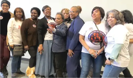  ?? LYNN SWEET/SUN-TIMES PHOTOS ?? Mayor Lori Lightfoot poses with supporters Saturday at a rally at a union hall. “Black women are fundamenta­lly the mayor’s core base,” campaign manager Valerie Martin said.