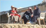  ?? — AFP ?? Women sit by the beach in Deir El Balah.