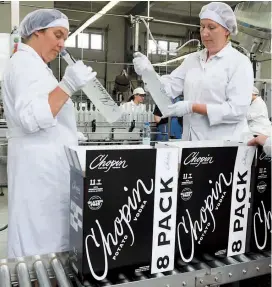  ??  ?? Employees on the production line at a vodka distillery in Chopin, Siedlce, Poland. Be it a source of national pride or negative stereotype­s, vodka is an integral part of Polish identity. — AFP