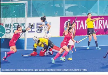  ??  ?? Japanese players celebrate after scoring a goal against India in the women’s hockey final in Jakarta on Friday