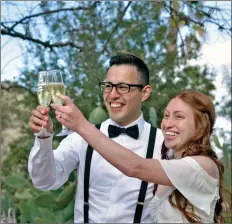  ?? Dan Watson/The Signal ?? Gustavo Gutierrez and Wendy Molina raise their glasses for a toast after being pronounced husband and wife during their micro-wedding Saturday at Tesoro Adobe Park in Valencia.