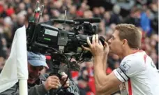 ?? PAUL ELLIS/AFP/GETTY IMAGES ?? Liverpool’s midfielder Steven Gerrard kisses a television camera in 2014.