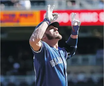  ??  ?? Toronto Blue Jays’ Josh Donaldson celebrates after homering against the Minnesota Twins on Sunday in Minneapoli­s. Donaldson had a pair of homers in a 13-7 loss, giving him 30 for the season, only the second Jay to hit 30 or more in each of his first...