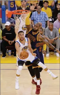  ?? TRIBUNE NEWS SERVICE ?? The Golden State Warriors' Stephen Curry (30) puts up a shot against the Cleveland Cavaliers' LeBron James (23) during Thursday's opening game of the NBA Finals.