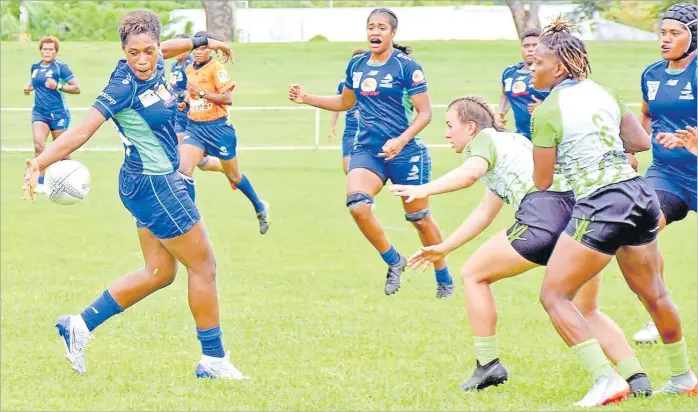  ?? Picture: REINAL CHAND ?? Rooster Chicken Fijiana Drua player Adita Miliana tries to control possession against the Rhinos Women’s rugby team during a trial match at Prince Charles Park in Nadi yesterday. The Fijiana Drua won 38-10.