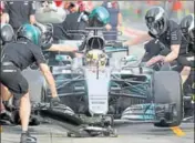  ?? AP PHOTO ?? Mechanics change Mercedes driver Lewis Hamilton’s tyres during the second practice session in Melbourne on Friday.