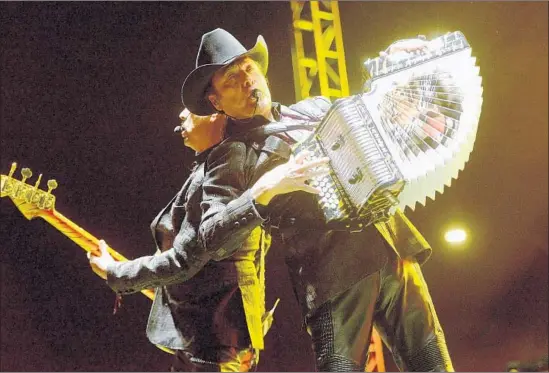  ?? Scott Dudelson Getty Images ?? LEAD SINGER Jorge Hernandez, right, and Los Tigres del Norte, performing in Long Beach last year, will make history as the first norteño act to play at the Bowl.