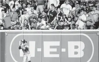  ?? Karen Warren / Staff photograph­er ?? Many Astros fans are willing to accept some risk to see a game again. “It’s just time,” one says.