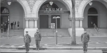  ?? DOUG MILLS, NEW YORK TIMES ?? National Guard soldiers stand for a motorcade outside Trump Internatio­nal Hotel during a rehearsal for the inaugurati­on on Jan. 15.