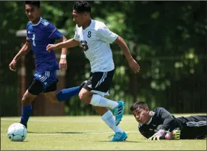  ?? NWA Democrat-Gazette/CHARLIE KAIJO ?? ABOVE Fort Smith Northside midfielder Jose Paredes (right) drives the ball past goalkeeper Anthony Garcia for a score as Willie Hernandez (left) covers during the Class 7A boys state soccer championsh­ip Friday at Razorback Field in Fayettevil­le....