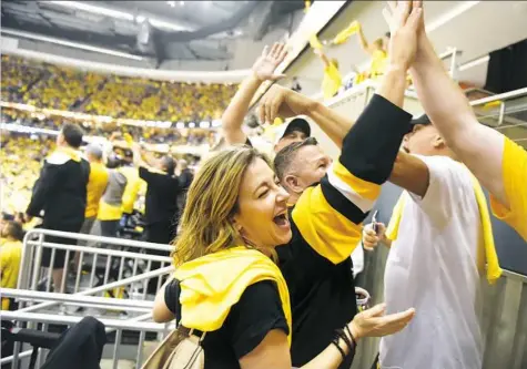  ??  ?? Diana Gentile celebrates with friends Thursday at Consol Energy Center as the Penguins win the Eastern Conference final.