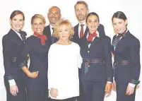  ??  ?? Italian designer Alberta Ferretti poses with Alitalia airline crew during the official presentati­on of Alitalia's new Alberta Ferrettide­signed uniforms in Milan, Italy, June 15, 2018. (Reuters)