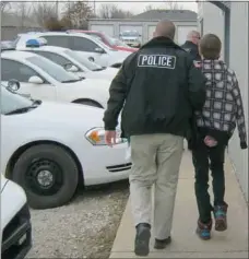  ??  ?? Pea Ridge Police Sgt. Lon Brown and Officer Chris Olson escort a youth into the Pea Ridge Police Station Monday afternoon. He was the fourth juvenile arrested for breaking into the city Street Department building and stealing two trucks the previous...