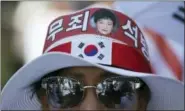  ?? LEE JIN-MAN — THE ASSOCIATED PRESS ?? A photo of former South Korean President Park Geun-hye is seen with letters reading “Innocence, Release” on a supporter’s head band during a rally to call for her release in Seoul, South Korea.