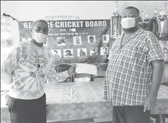  ?? ?? West Indies batsman Shimron Hetmyer (left) hands over contributi­on to RHTYSC Secretary Hilbert Foster.