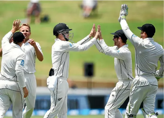  ?? PHOTOSPORT ?? New Zealand players celebrate the fall of another wicket en route to winning the second test against West Indies in Hamilton yesterday.