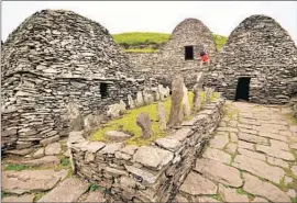  ?? Margo Pfeiff ?? THE BEEHIVE- LIKE stone structures at Skellig Michael, a UNESCOWorl­d Heritage Site off the Ireland coast, were built by 7th century Christian monks.