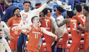  ??  ?? Syracuse's Joseph Girard III, a Glens Falls graduate, celebrates following a second-round stunner over third-seeded West Virginia on Sunday. Girard finished with 12 points, seven assists and six rebounds.