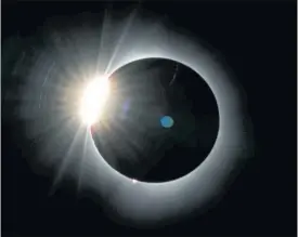  ?? THE ASSOCIATED PRESS ?? The moon covers most of the the sun as it approaches the total solar eclipse, as seen from the summit of Saddleback Mountain near Rangeley, Maine.