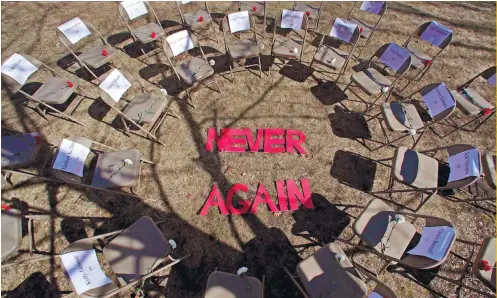  ?? AP FOTO ?? TRAUMA: Students, in a silent protest, put up a ring of chairs with the words “NEVER AGAIN” on the 19th anniversar­y of the Columbine High School shooting. The inner chairs have the names of the victims, while the outer chairs have the Parkland victims’...