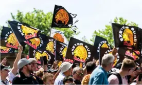  ?? Photograph: Rogan/JMP/Shuttersto­ck ?? Exeter fans holding Chiefs flags. The estimated cost of a full rebranding exercise at the club is in the region of £700,000.